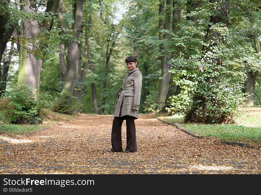 Beautiful woman walking in the autumn park. Beautiful woman walking in the autumn park