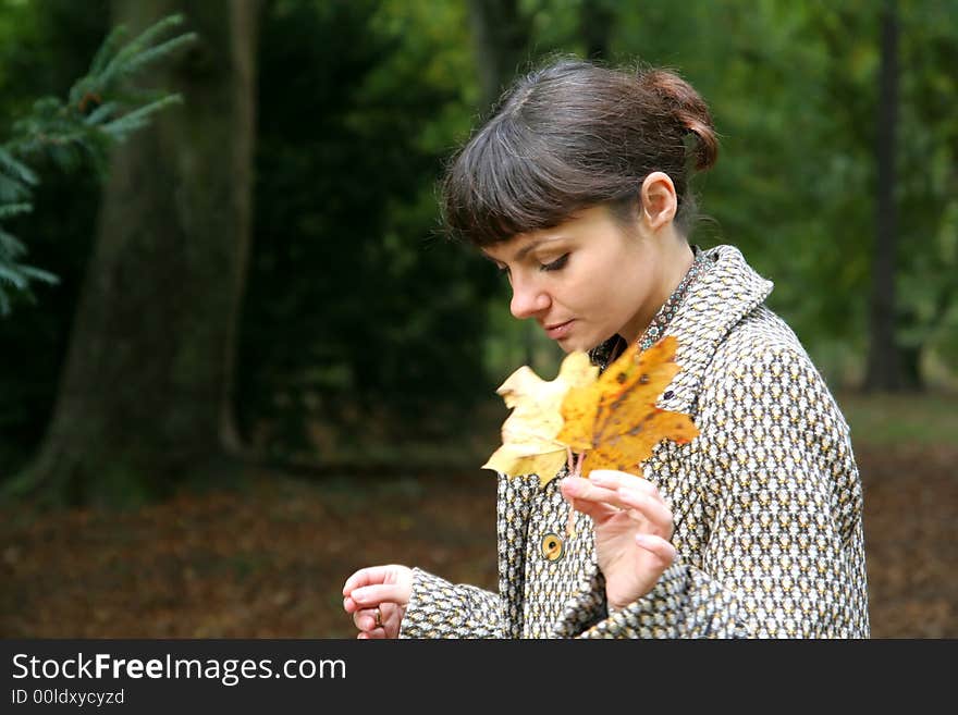 Beautiful woman walking in the autumn park. Beautiful woman walking in the autumn park