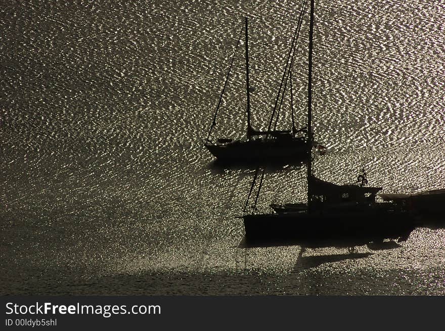 Sailing boats anchored in a harbour at sunrise. Sailing boats anchored in a harbour at sunrise