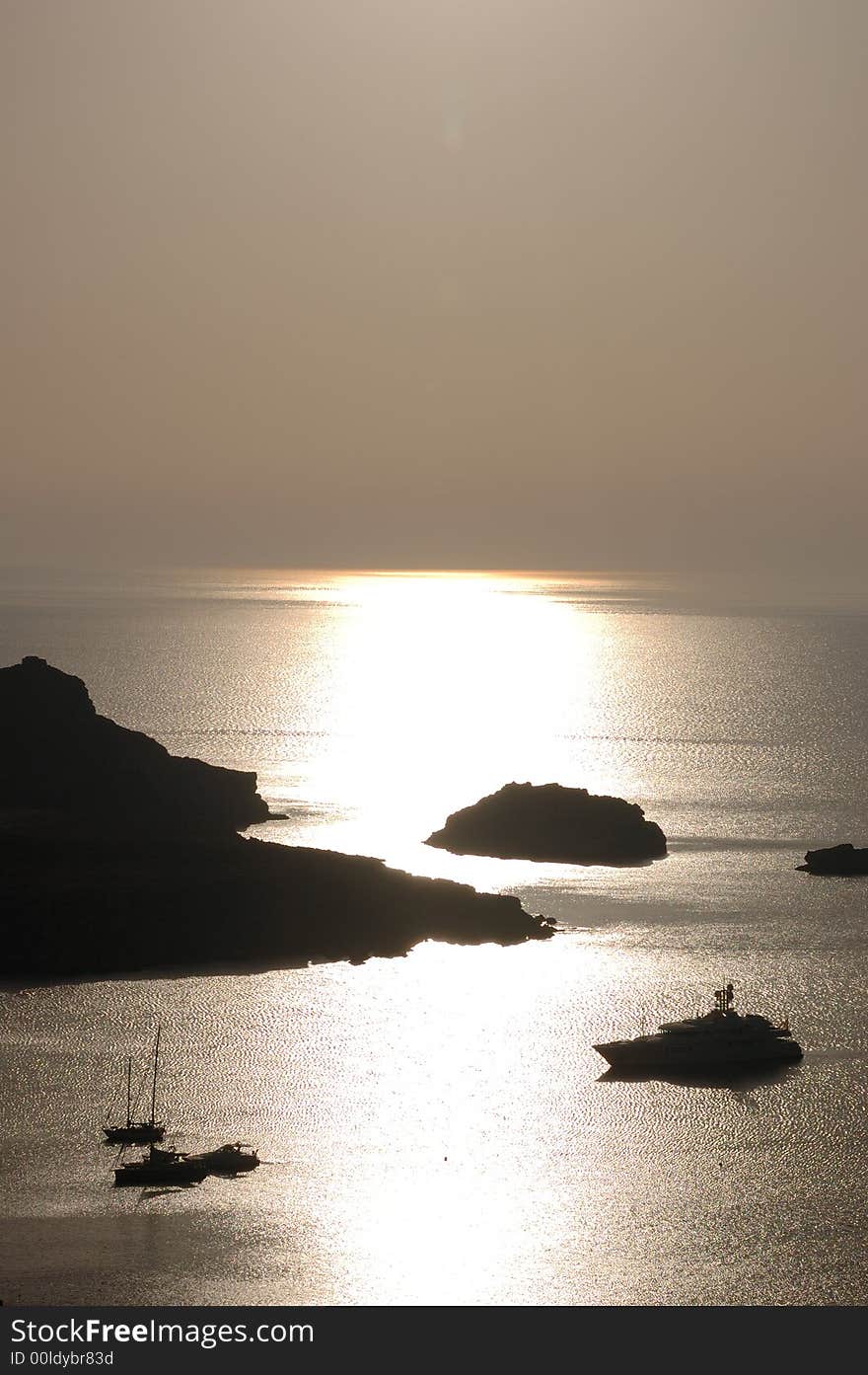 Sailing boats anchored in a harbour at sunrise. Sailing boats anchored in a harbour at sunrise