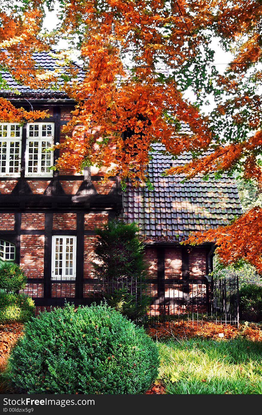 Half-timbered house with front-garden in autumn colors