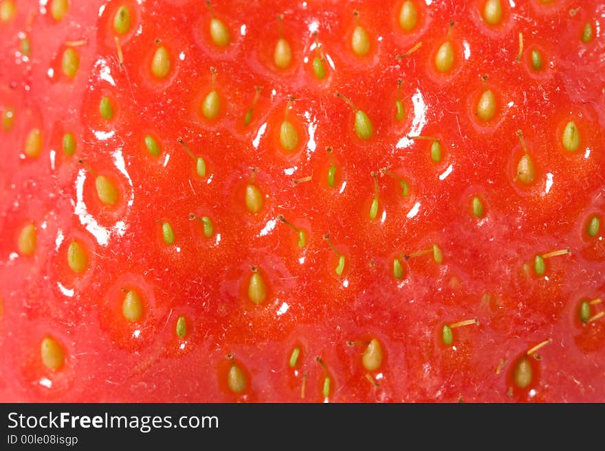 Ripe strawberry macro. Red background.