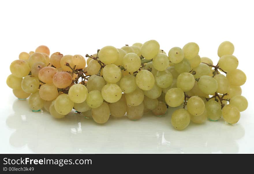 Cluster of green tasty grapes on a white background