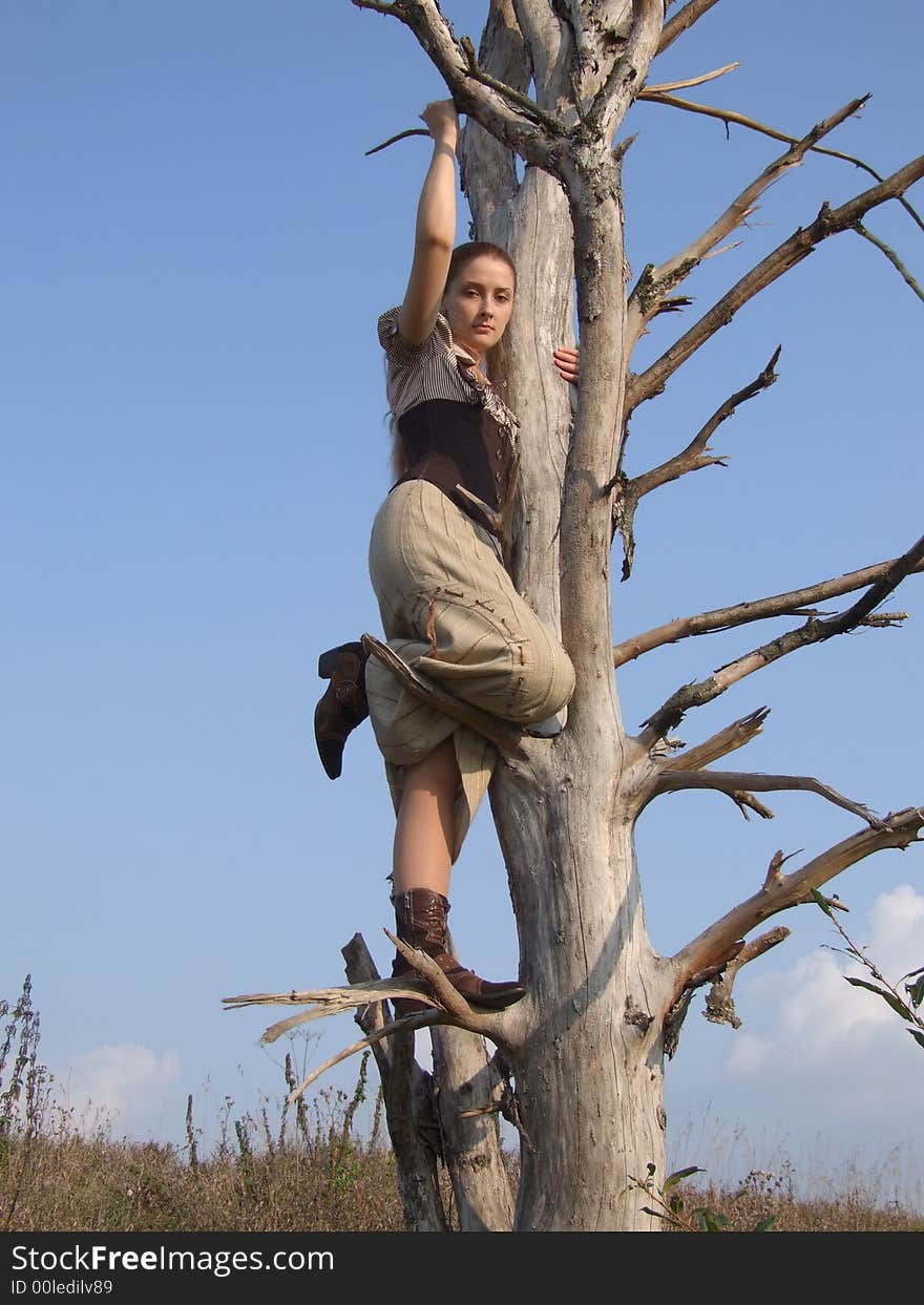 Girl On A Tree In Autumn In A Park