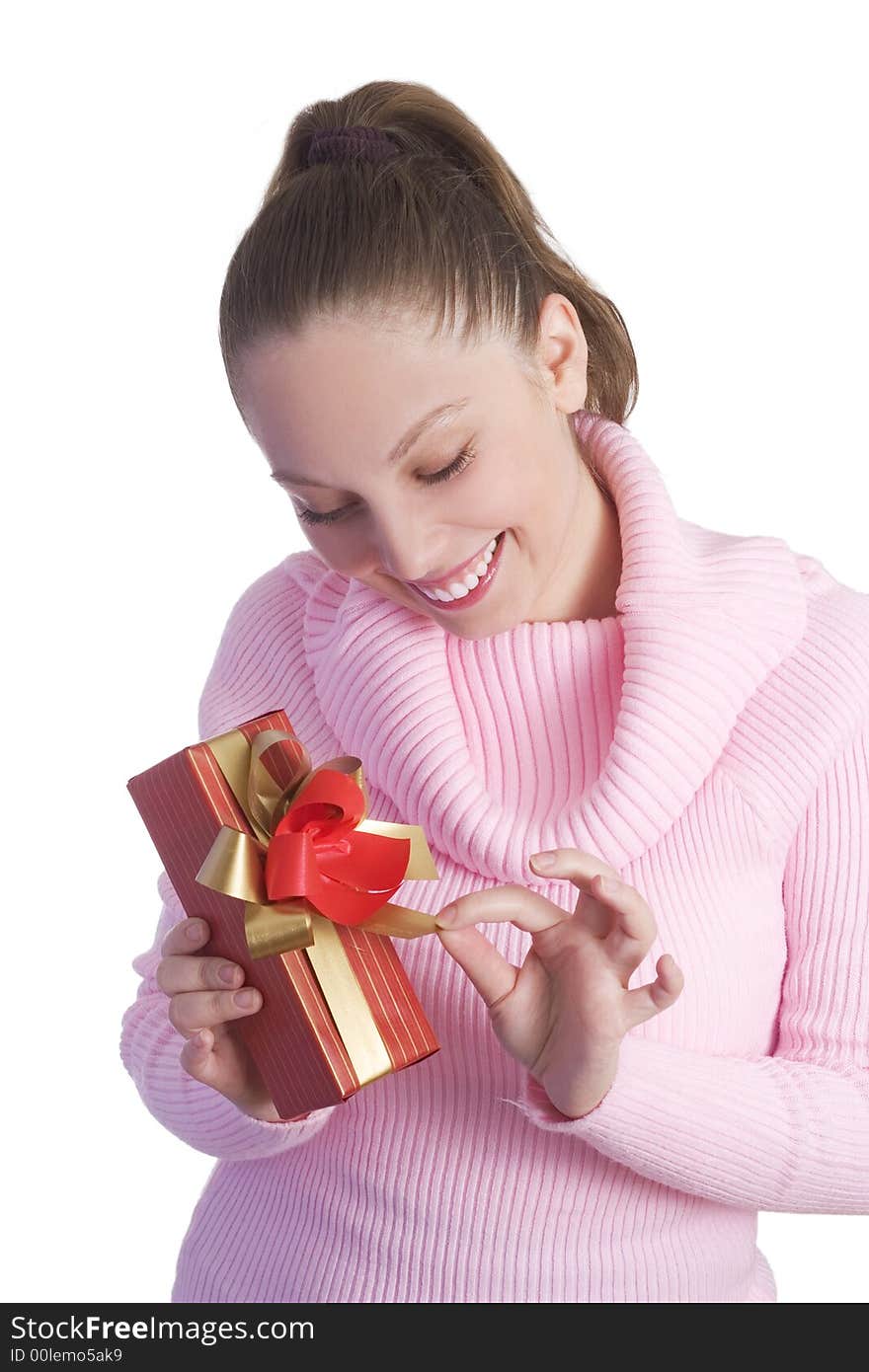 Beautiful young girl in pink holding red gift isolated on white background. Beautiful young girl in pink holding red gift isolated on white background