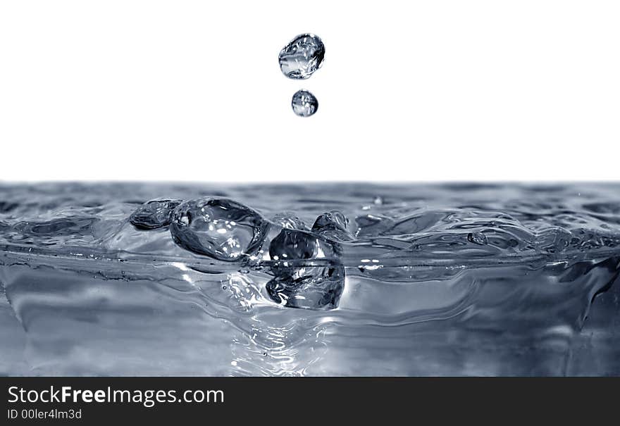 Isolated blue drops are falling down and impact with liquid surface. Isolated blue drops are falling down and impact with liquid surface