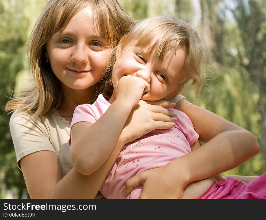 The senior sister holds on hands younger. The senior sister holds on hands younger