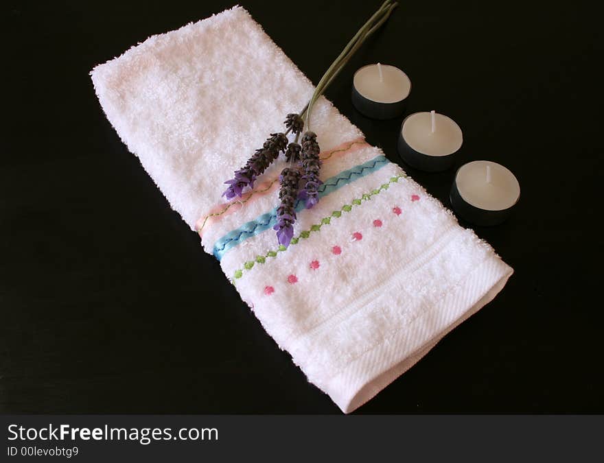 White face cloth with lavender and candles