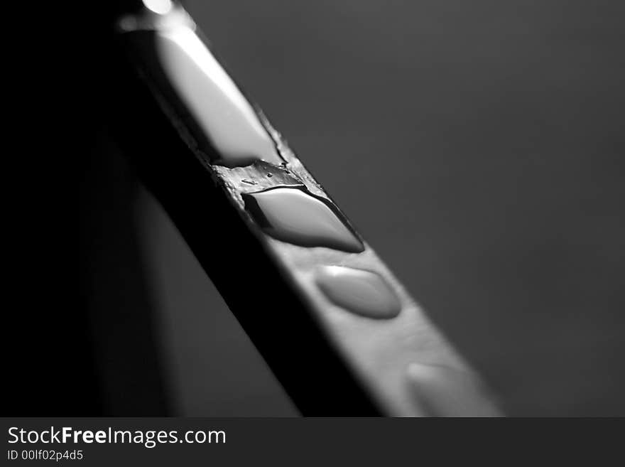 Drops of water resting on a railing