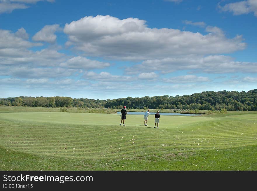 Group Of Golfers At The Green