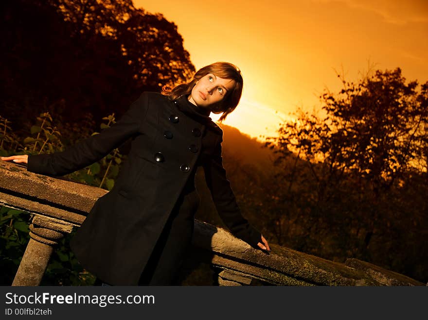 Beautiful thinking girl at sunset time