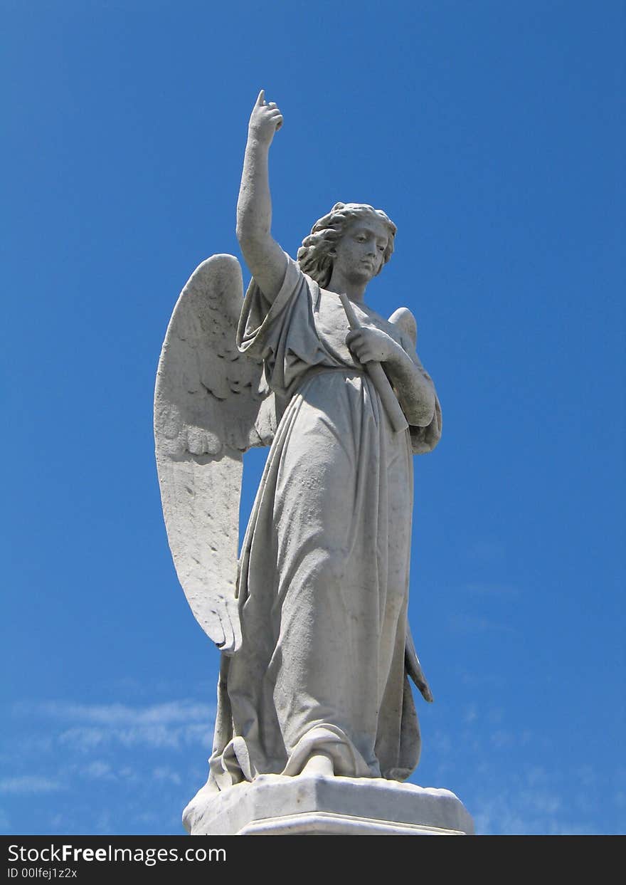 Detail of winged angel against blue sky. Detail of winged angel against blue sky