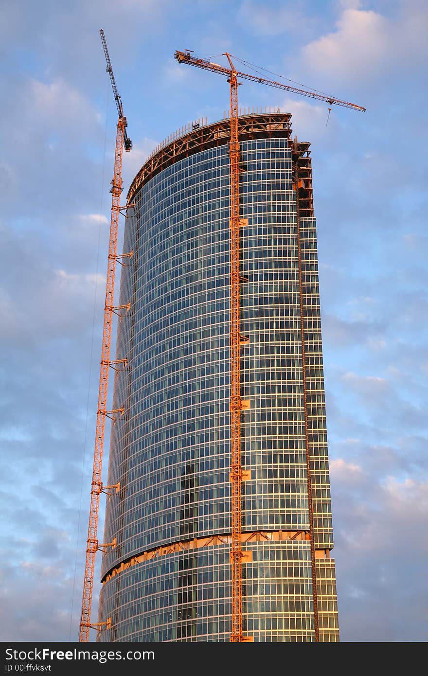 Skyscraper`s construction with two building cranes. Skyscraper`s construction with two building cranes