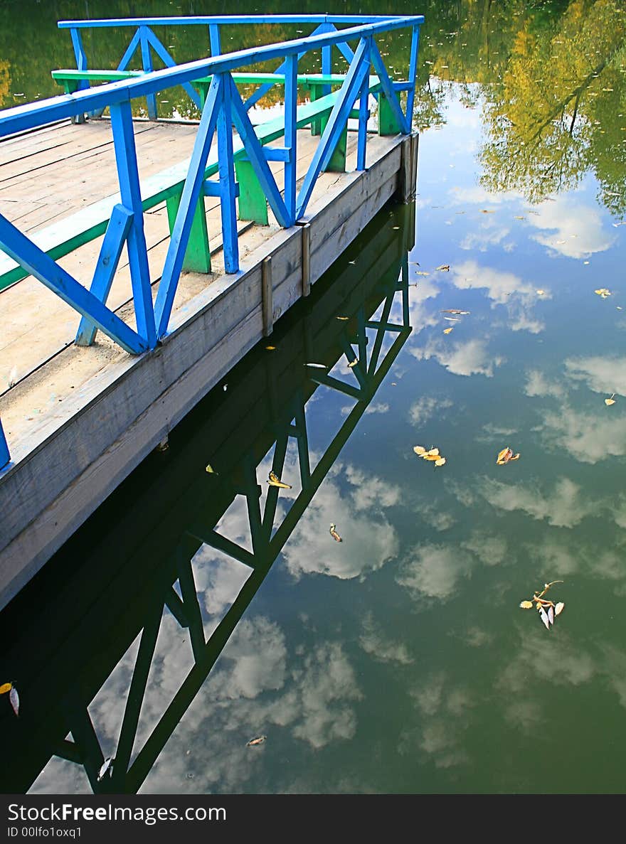 Wooden Mooring Reflected In Wa