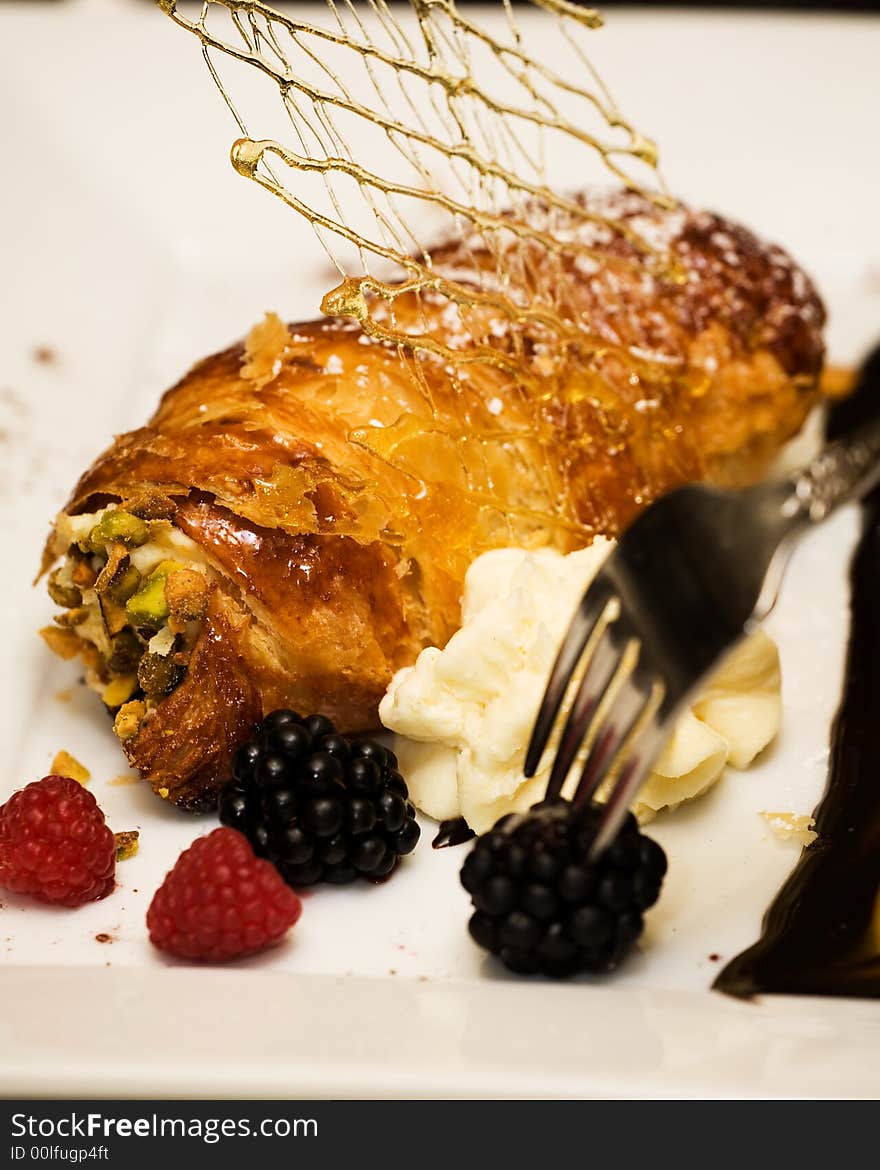 Macro of a professionally prepared gourmet berry and pastry dessert served as the last course of a reception. Macro of a professionally prepared gourmet berry and pastry dessert served as the last course of a reception