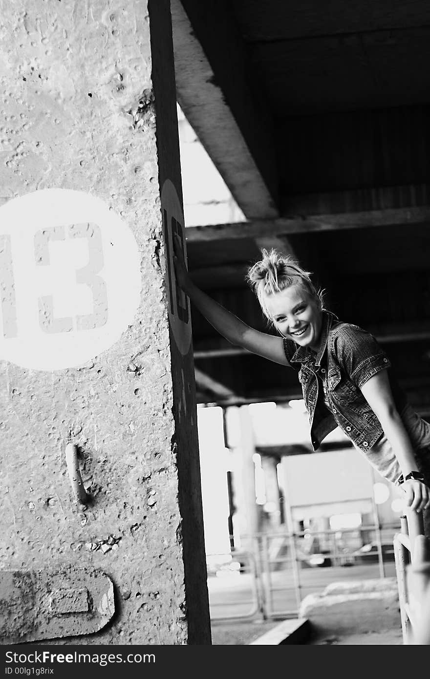 A young woman dressed in a jeans and laughing. A young woman dressed in a jeans and laughing