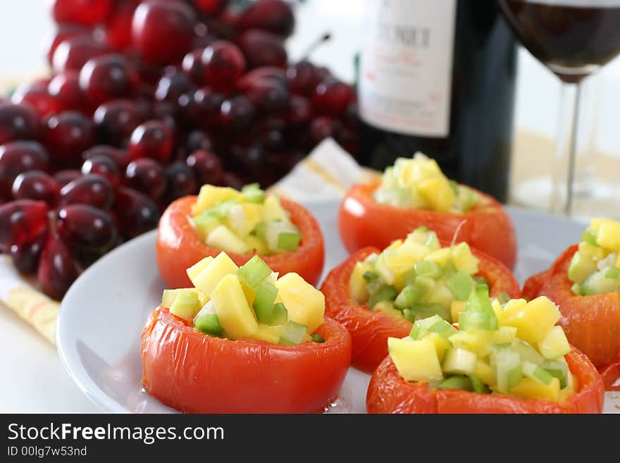 Large carved baked tomatoes with miniature mango and star fruit filling