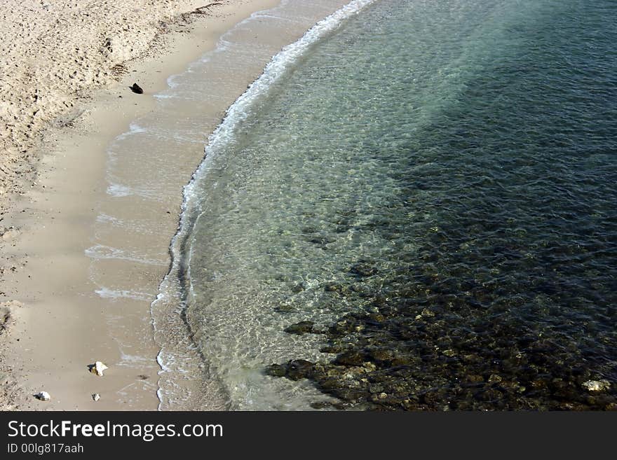 Free of tourists beach and transparent emerald water of the Mediterranean sea (French riviera, coast azure part) during velvet season.