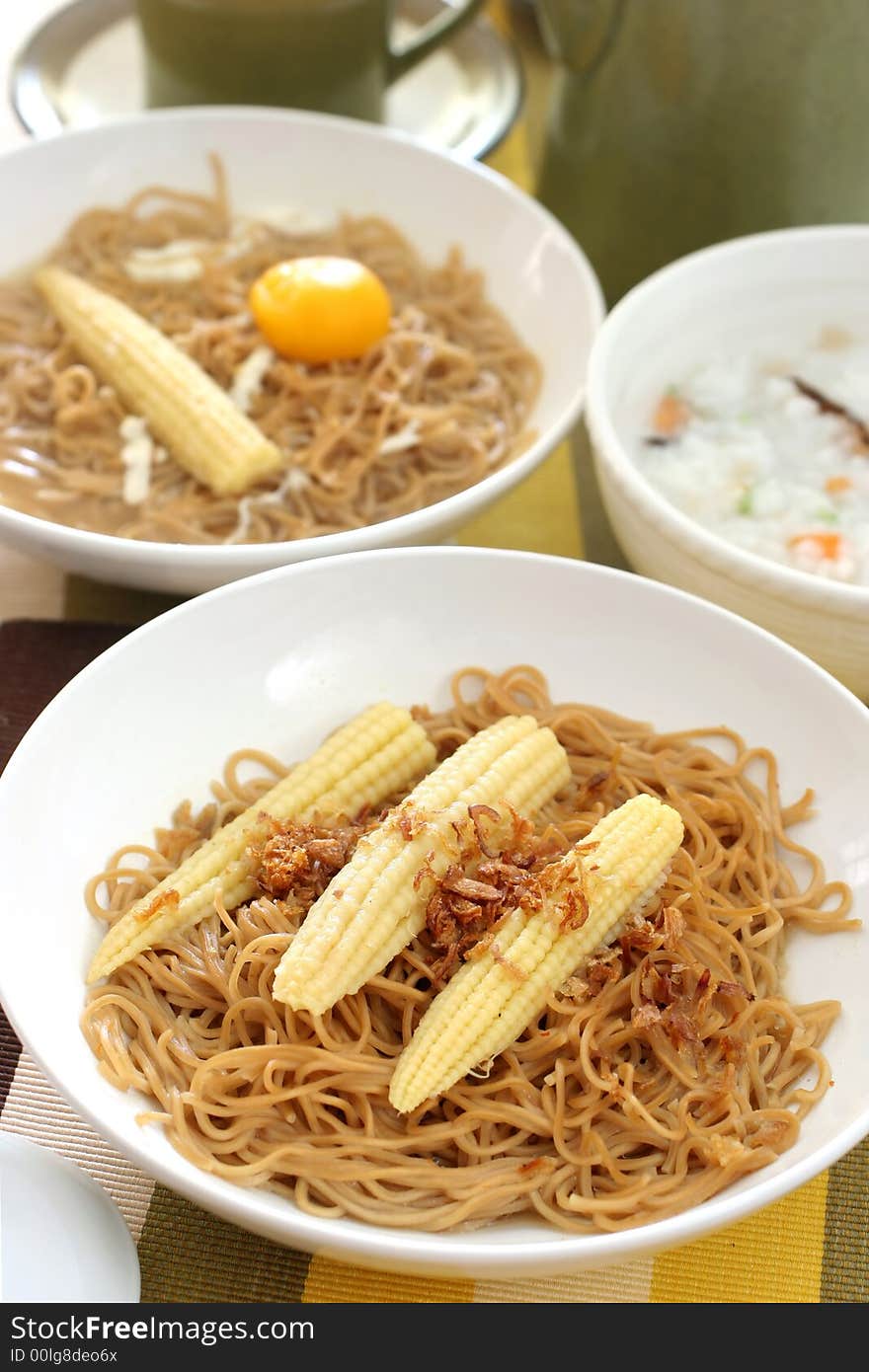 Brown Chinese buckwheat noodles with baby corn in light soup