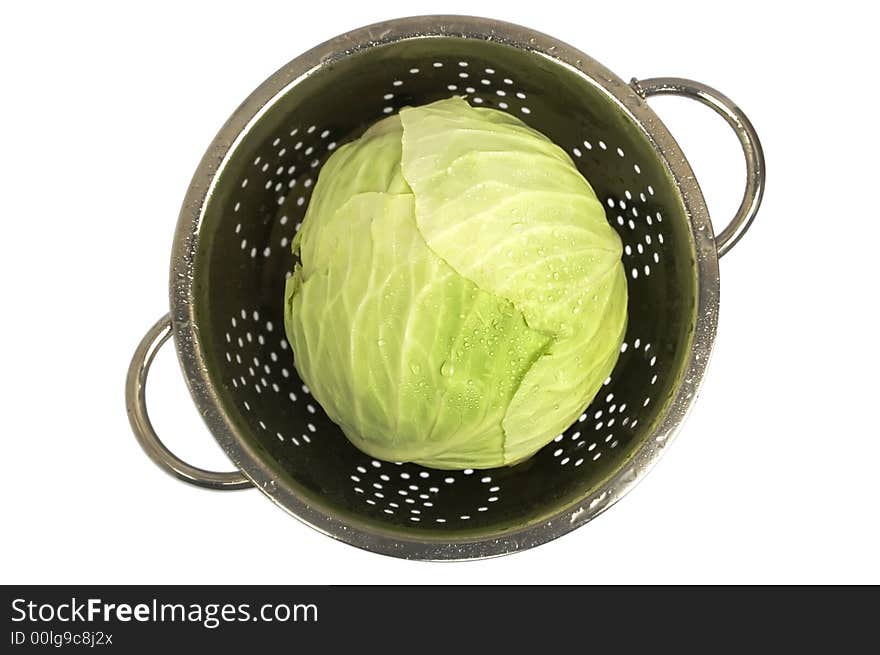 Just washed fresh cabbage in a colander with water-drops. On isolated on white background. Top view. Just washed fresh cabbage in a colander with water-drops. On isolated on white background. Top view.