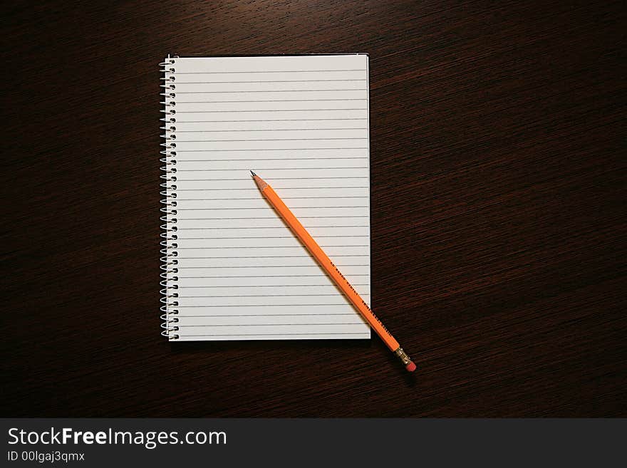 A Notebook and a Pencil on the Office Table