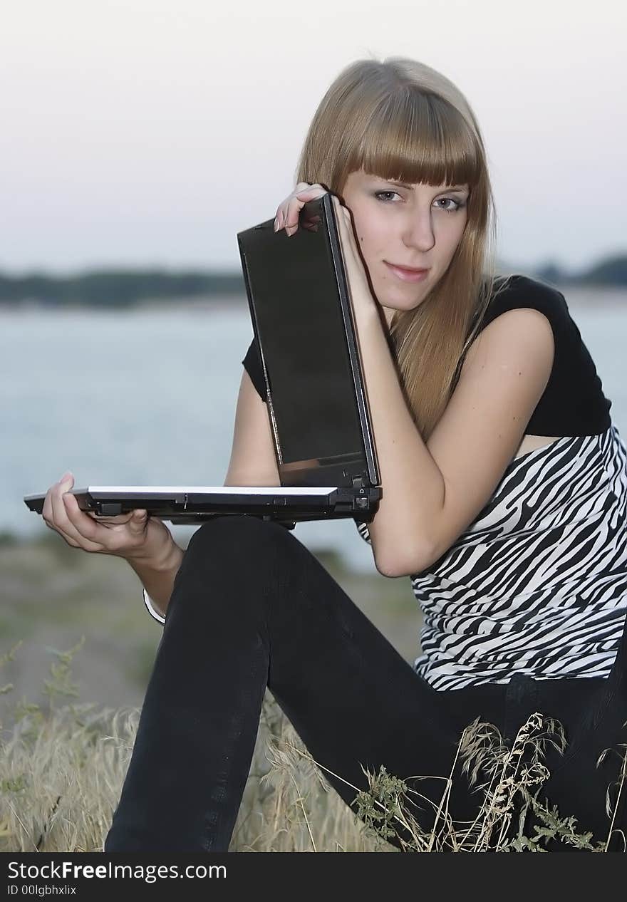 Young happy woman with her laptop. Young happy woman with her laptop