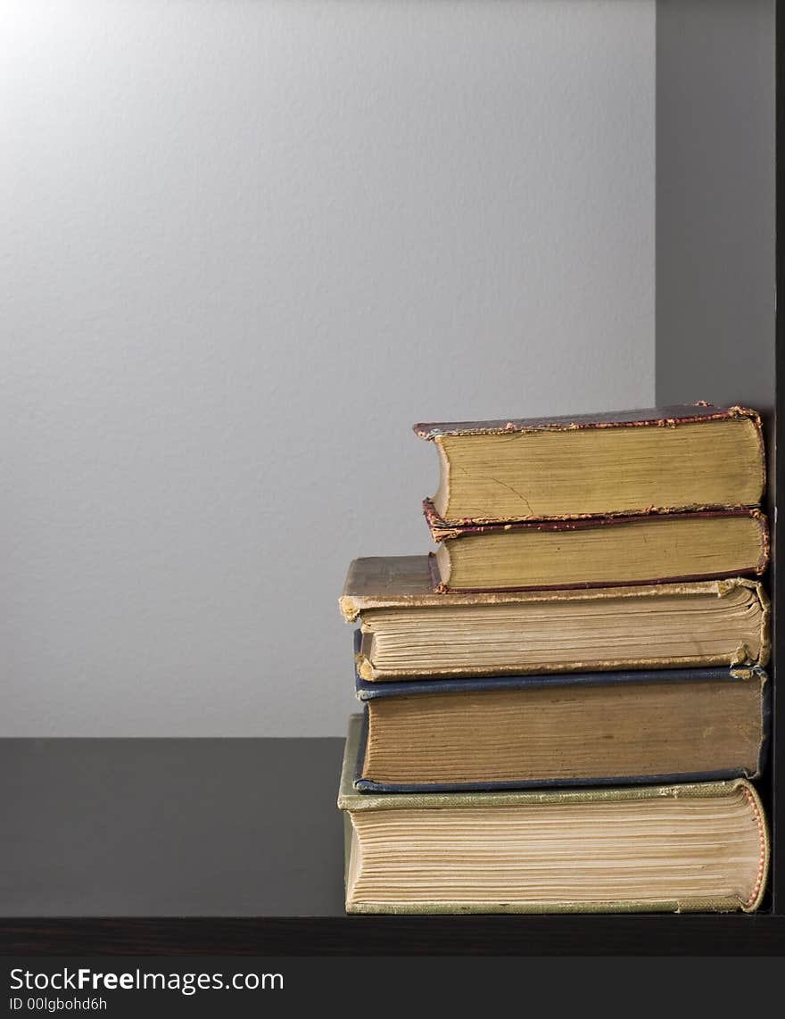 Old books in pile on book shelf. Old books in pile on book shelf