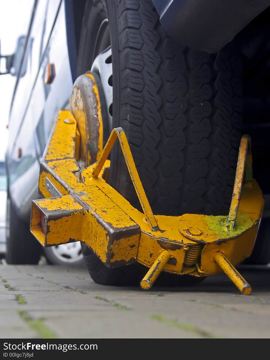 Yellow wheelscrew on a carwheel in Amsterdam city in the Netherlands