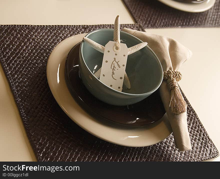 A casual place setting with a coastal theme. A casual place setting with a coastal theme