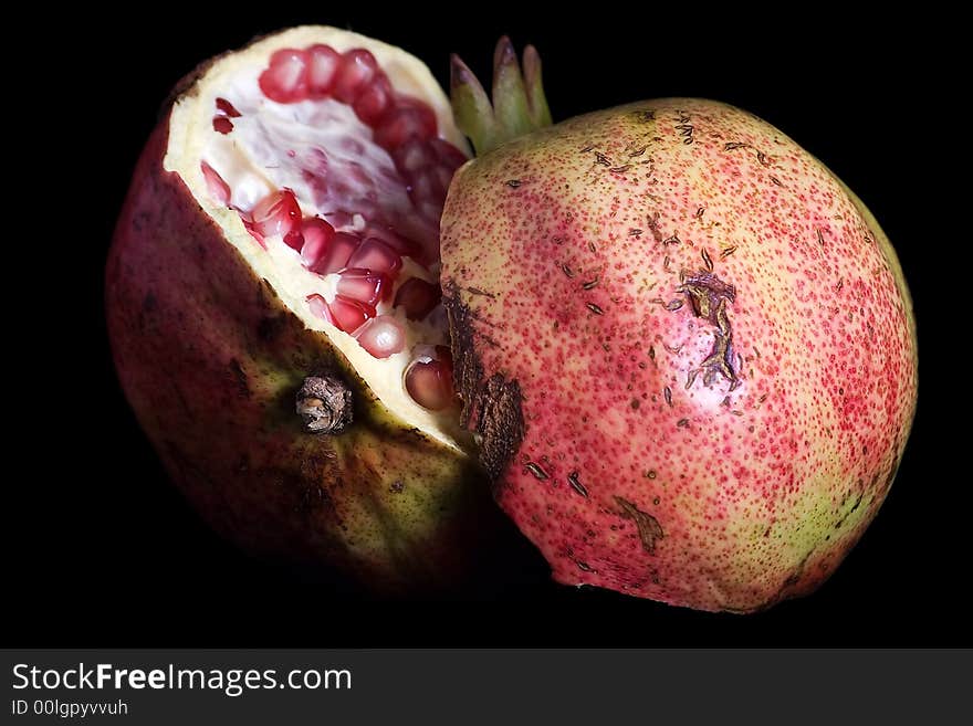 Pomegranate isolated on black background.