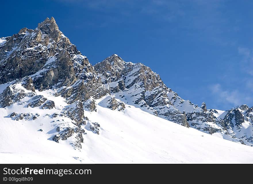 Snowed mountainrange with visible rocks. Snowed mountainrange with visible rocks