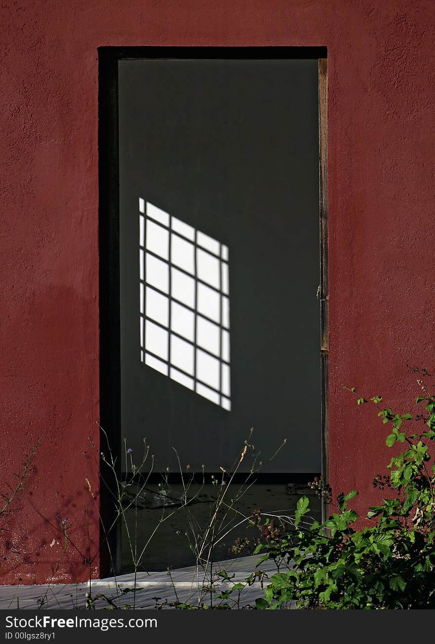 Window traces its shadow over the wall. Window traces its shadow over the wall