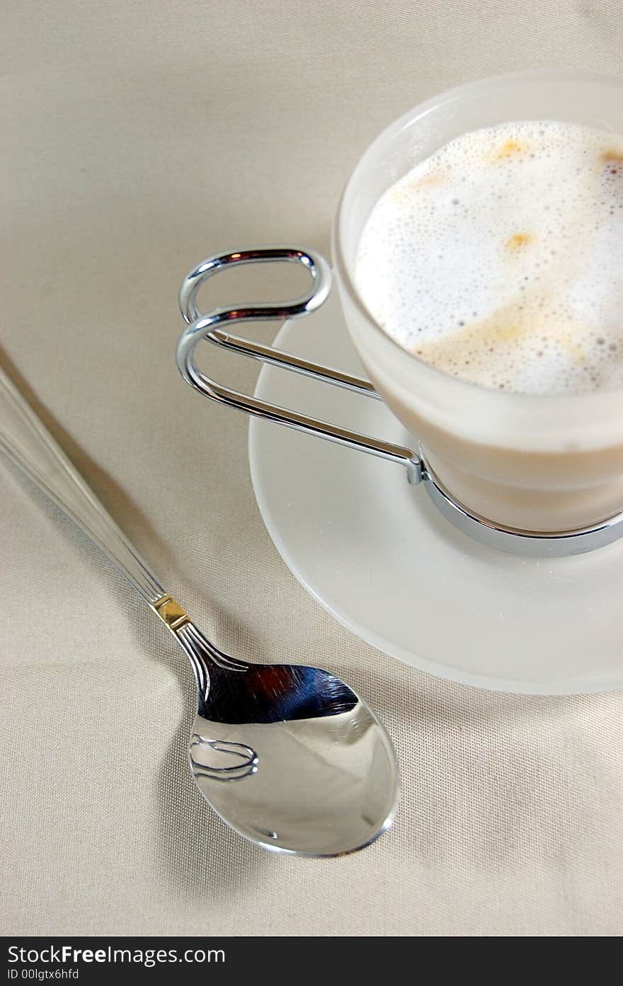 Cup of cappuccino with spoon. Cup of cappuccino with spoon