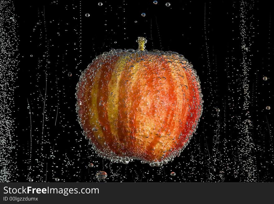 Fresh, clean apple in clear, bubbly liquid on a black background. Fresh, clean apple in clear, bubbly liquid on a black background.