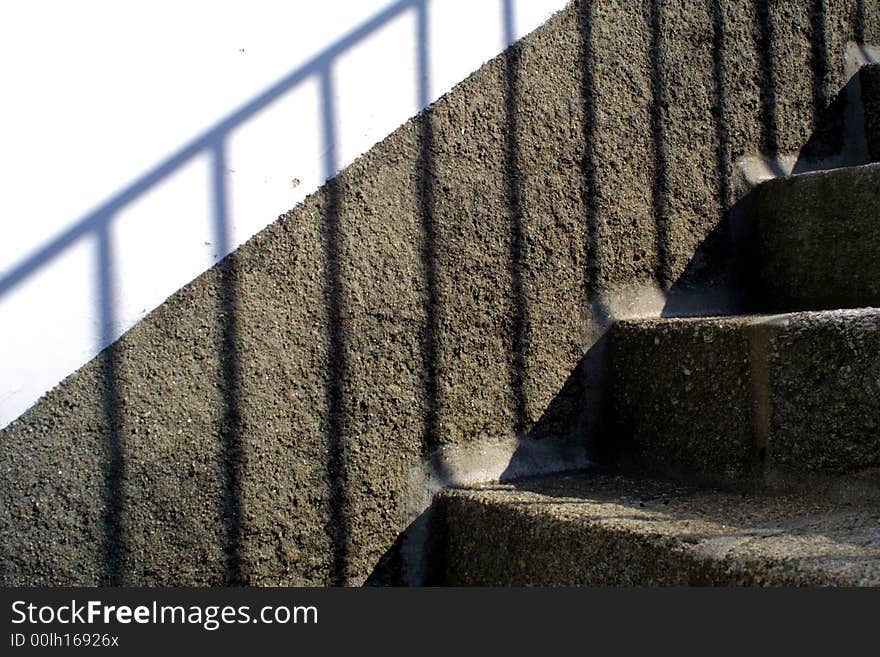 Background with granite wall and stairs and shadow in a white wall