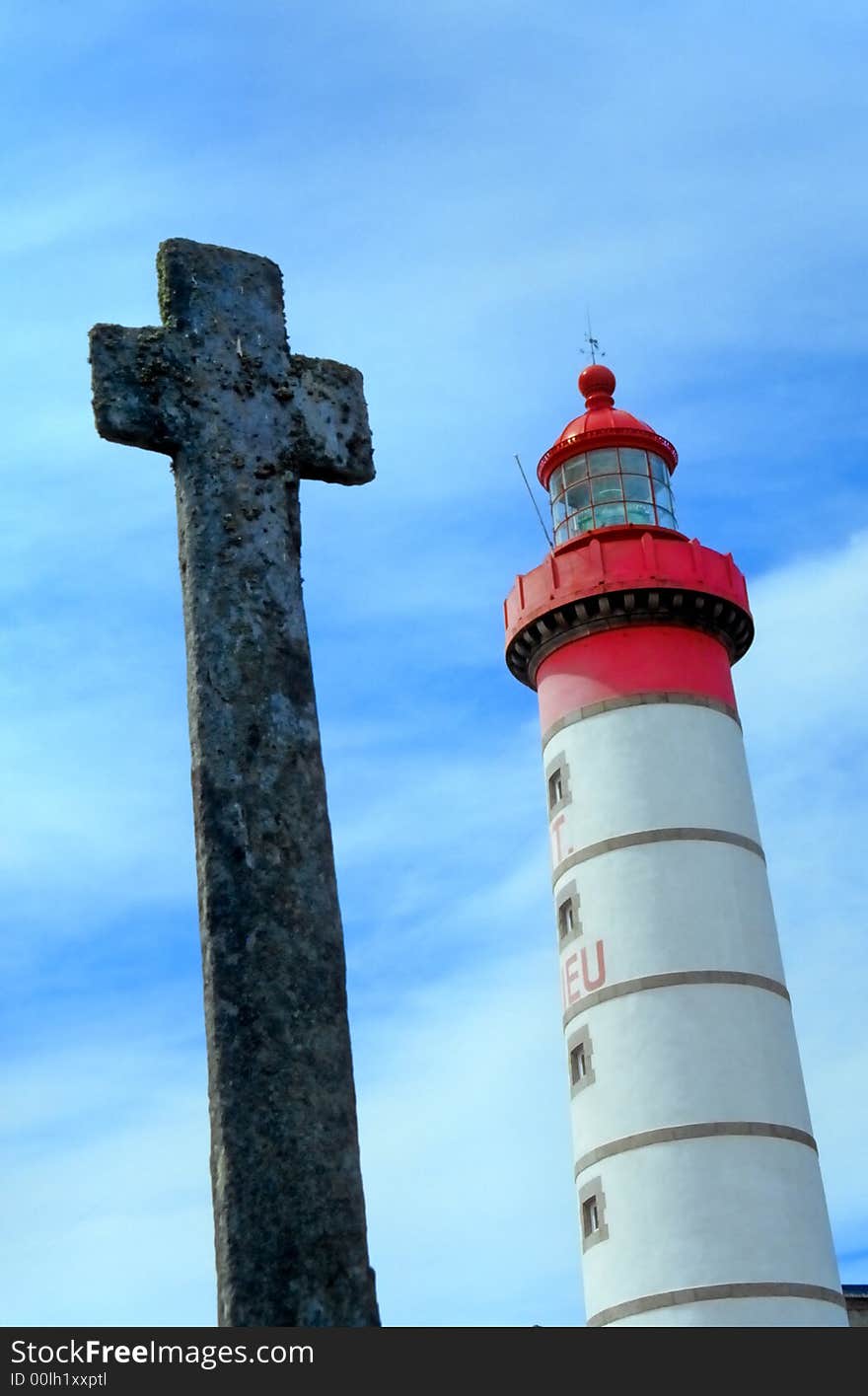 Lighthouse and ancient Celtic cross on the coast of Brittany. Lighthouse and ancient Celtic cross on the coast of Brittany