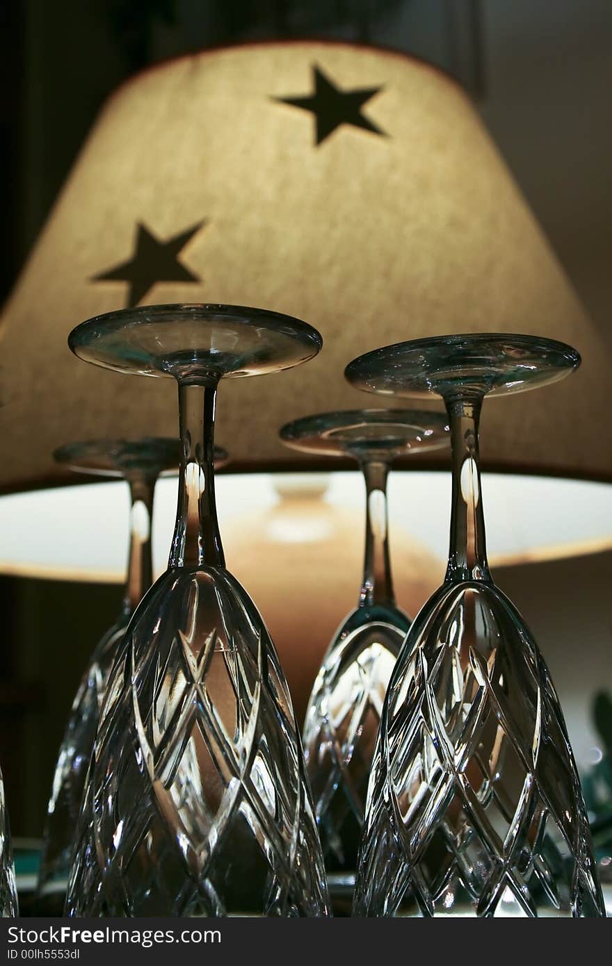 Closeup of champagne glasses against a table lamp. Closeup of champagne glasses against a table lamp