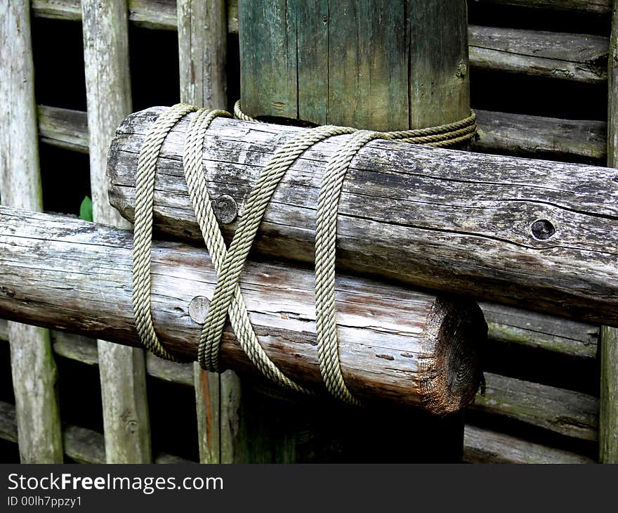 A shot of a log type fence that is tied together with rope. A shot of a log type fence that is tied together with rope.