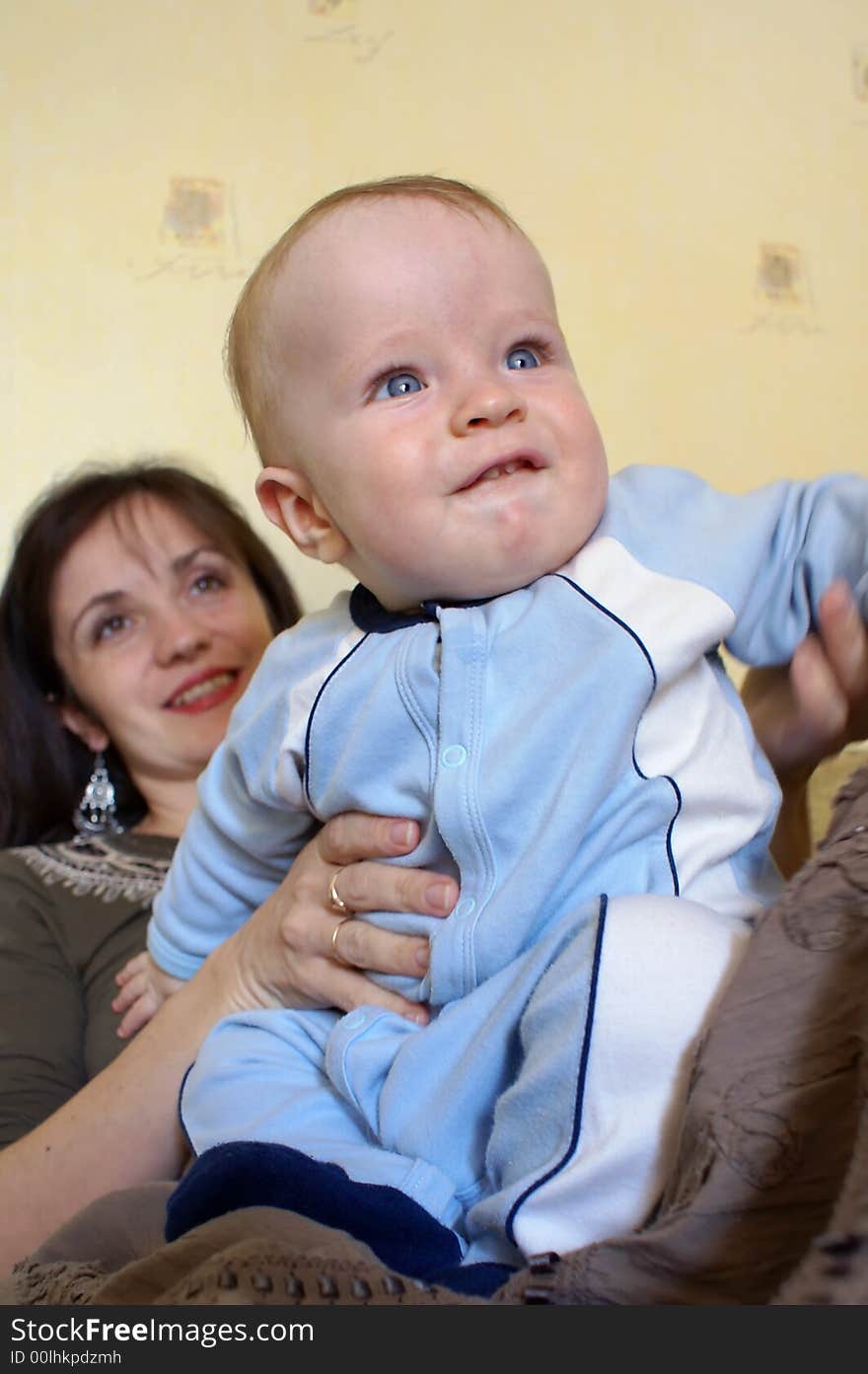 The joyful baby at mum on hands