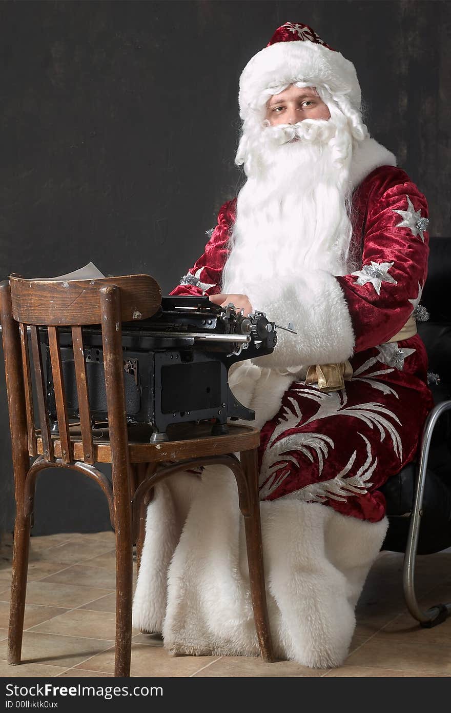 Santa Claus typing a letter on an typewriter. Santa Claus typing a letter on an typewriter