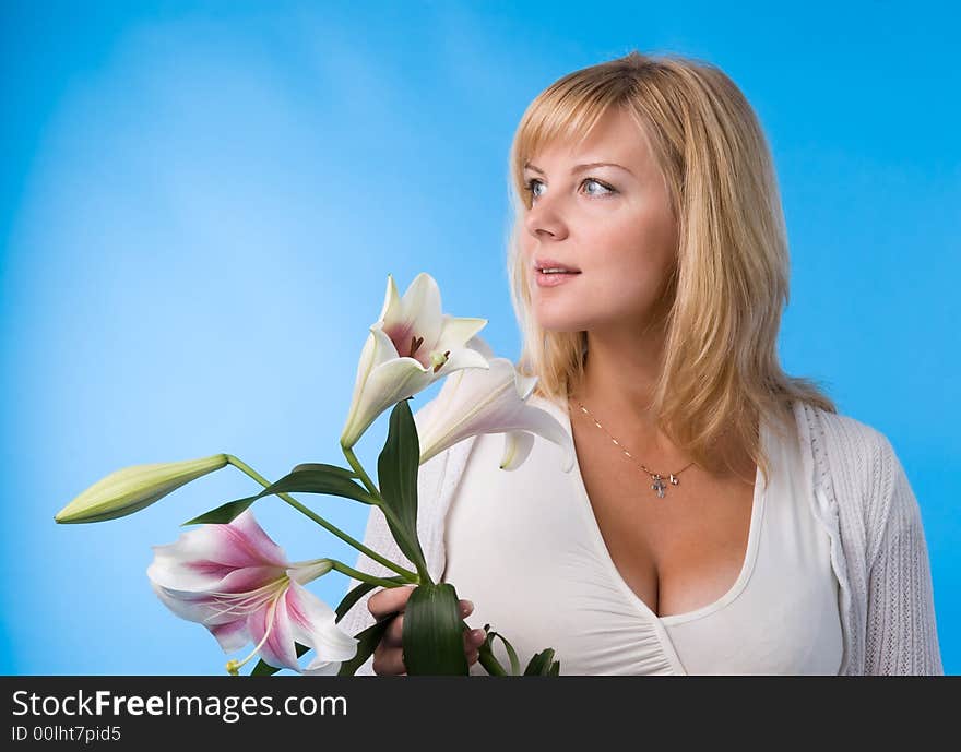 The attractive woman holds a liliy in hands. The attractive woman holds a liliy in hands