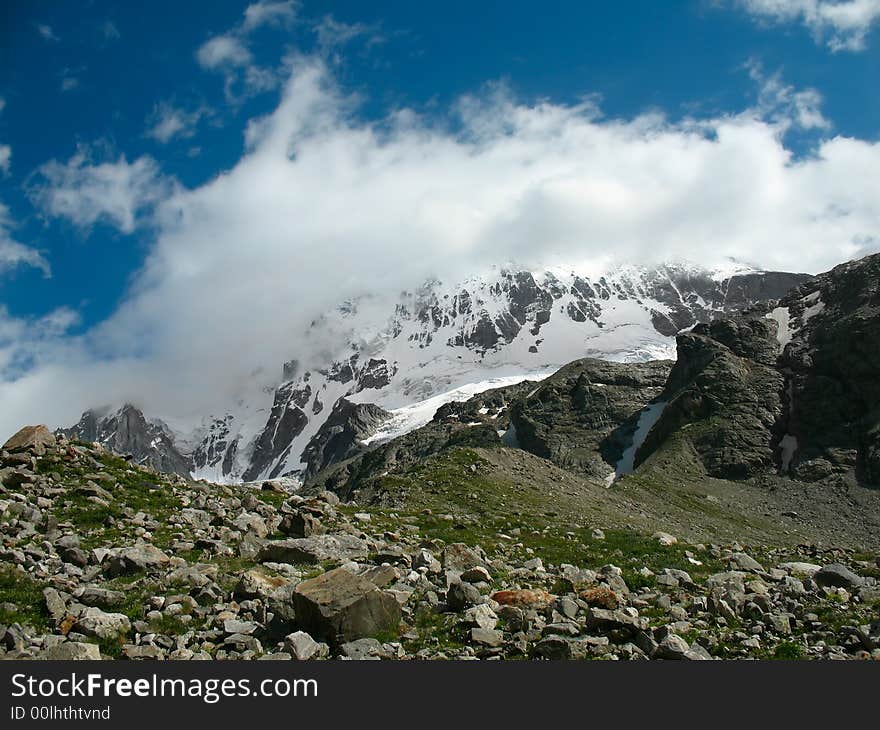 Landscape with high mountains, snowy peaks and blue sky. Landscape with high mountains, snowy peaks and blue sky