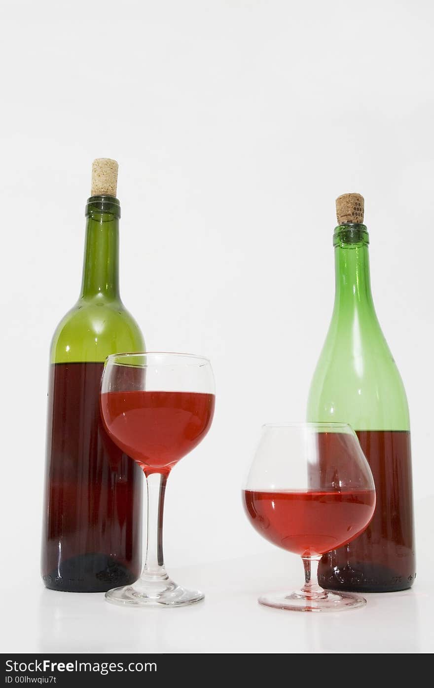 Red wine bottles and glasses isolated over white. Red wine bottles and glasses isolated over white