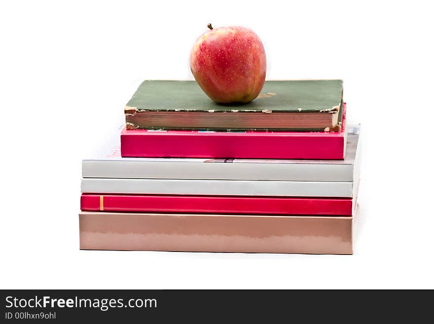 Fresh red apple on stack of books - isolated on white. Fresh red apple on stack of books - isolated on white