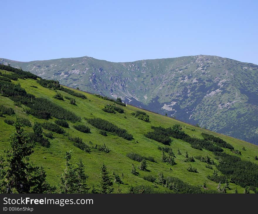 Two mountain's needles and fantastic green hillside. Two mountain's needles and fantastic green hillside