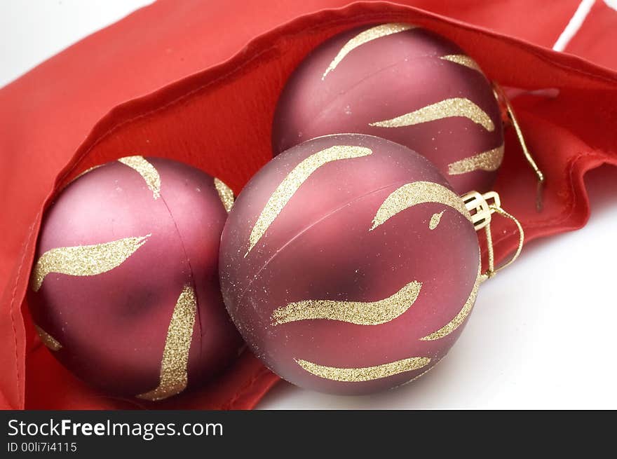 Red Christmas tree decorations on red satin. Red Christmas tree decorations on red satin.