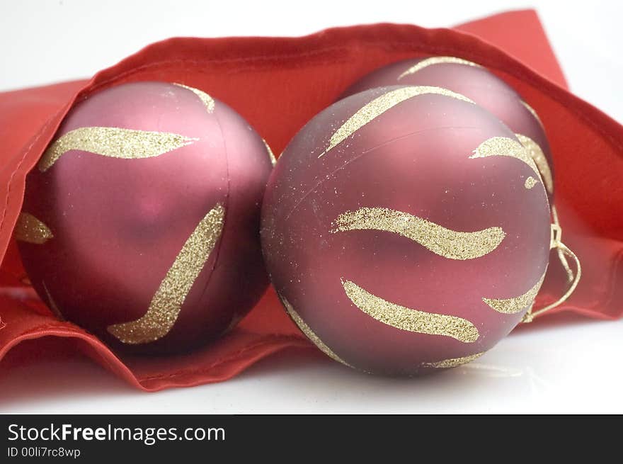 Red Christmas tree decorations on red satin. Red Christmas tree decorations on red satin.