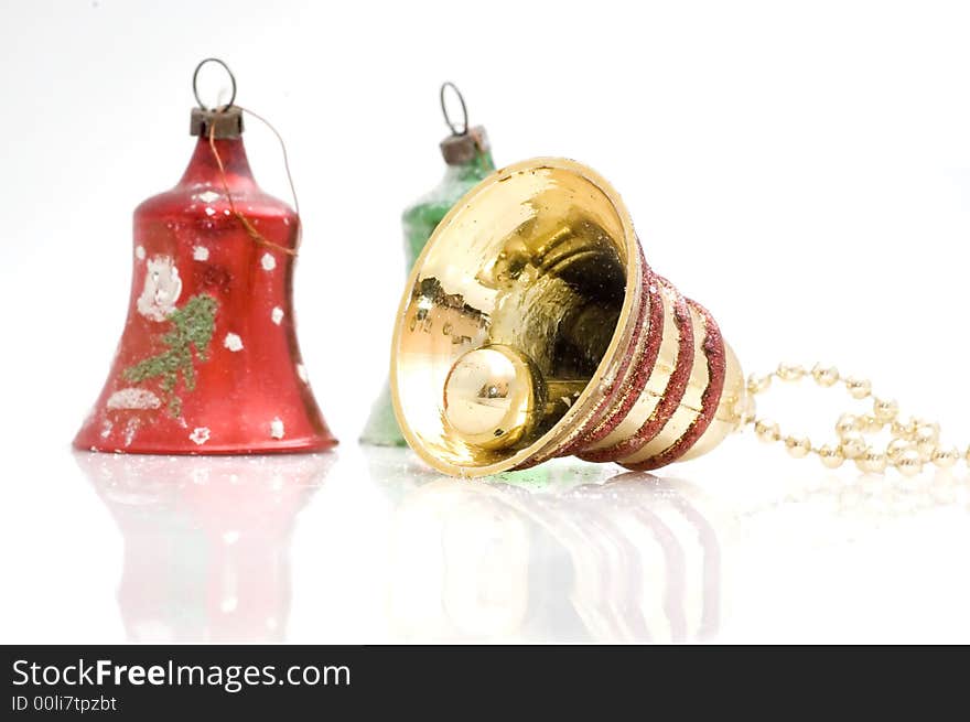 Christmas tree decoration bell on white background. Golden one.