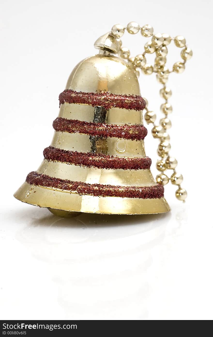 Christmas tree decoration bell on white background. Golden one.