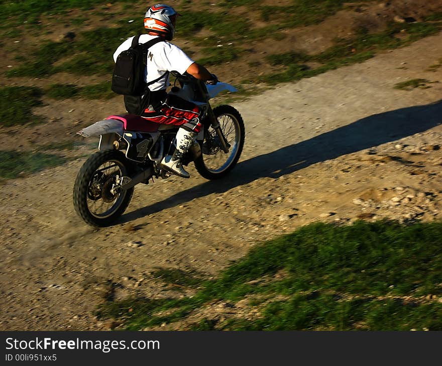 Man driving a moto-cross bike. Man driving a moto-cross bike